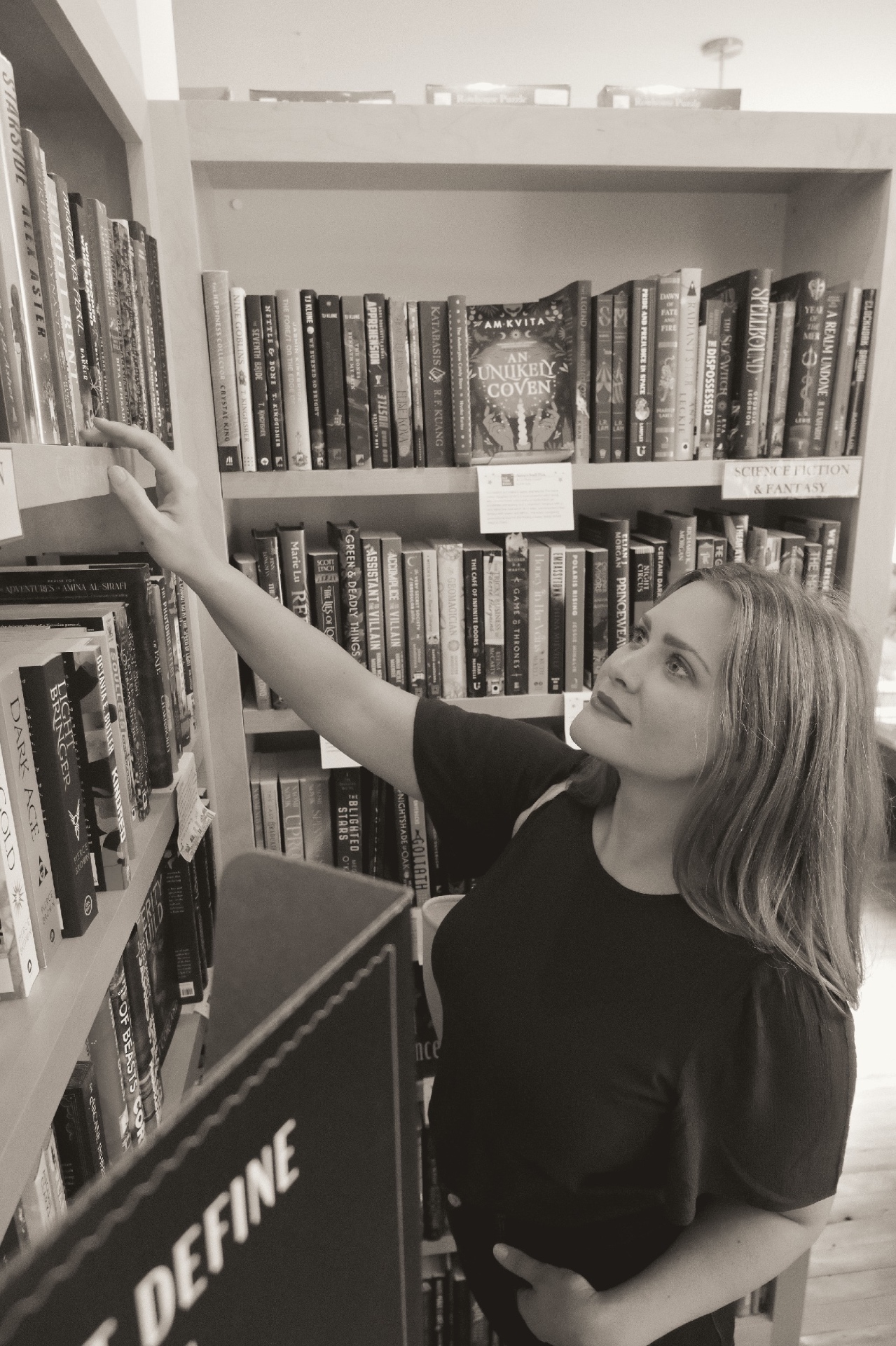 Karen browsing the science fiction and fantasy shelves at a bookstore